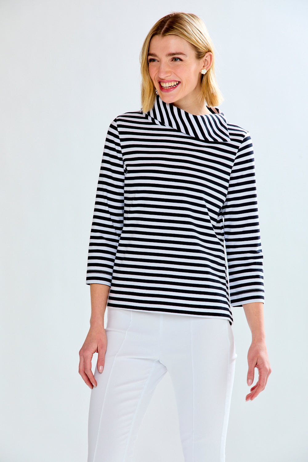 Woman in a white and black striped knit top
