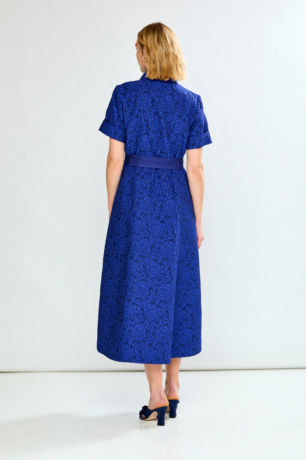 Woman in blue dress with bow