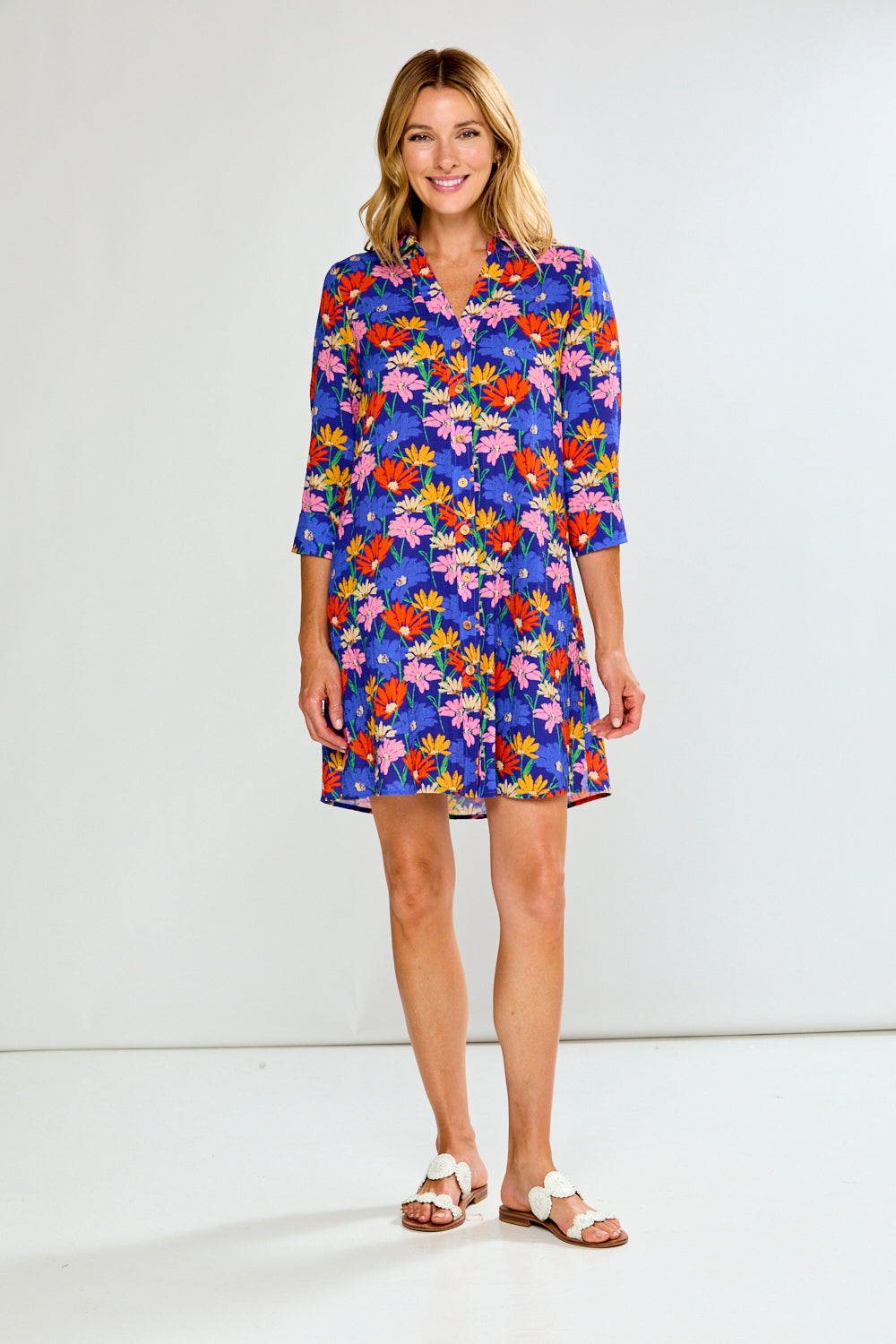Woman wearing a colorful floral dress on a white background