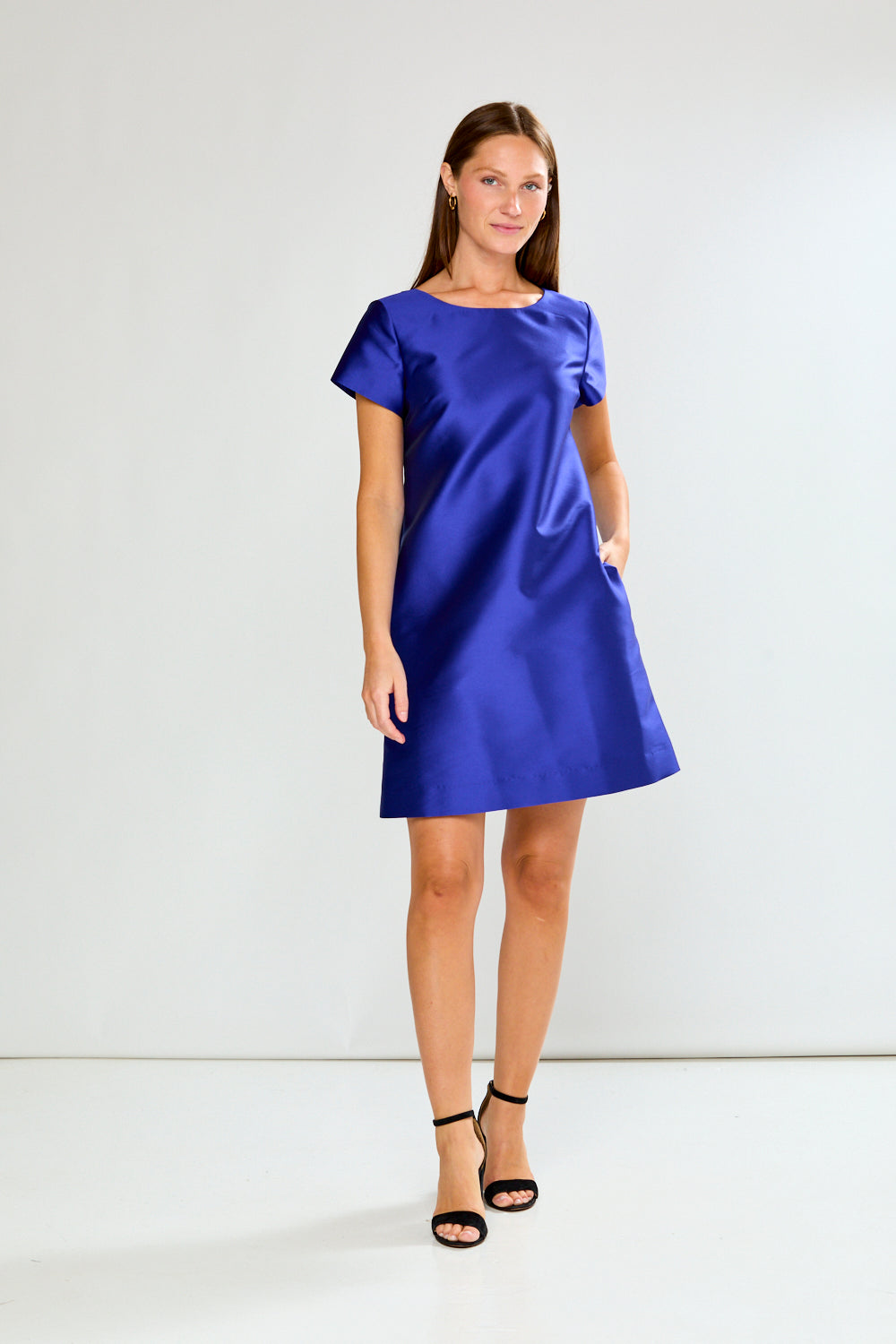 Woman wearing a blue dress against a white background
