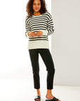 Woman in black and white striped sweater