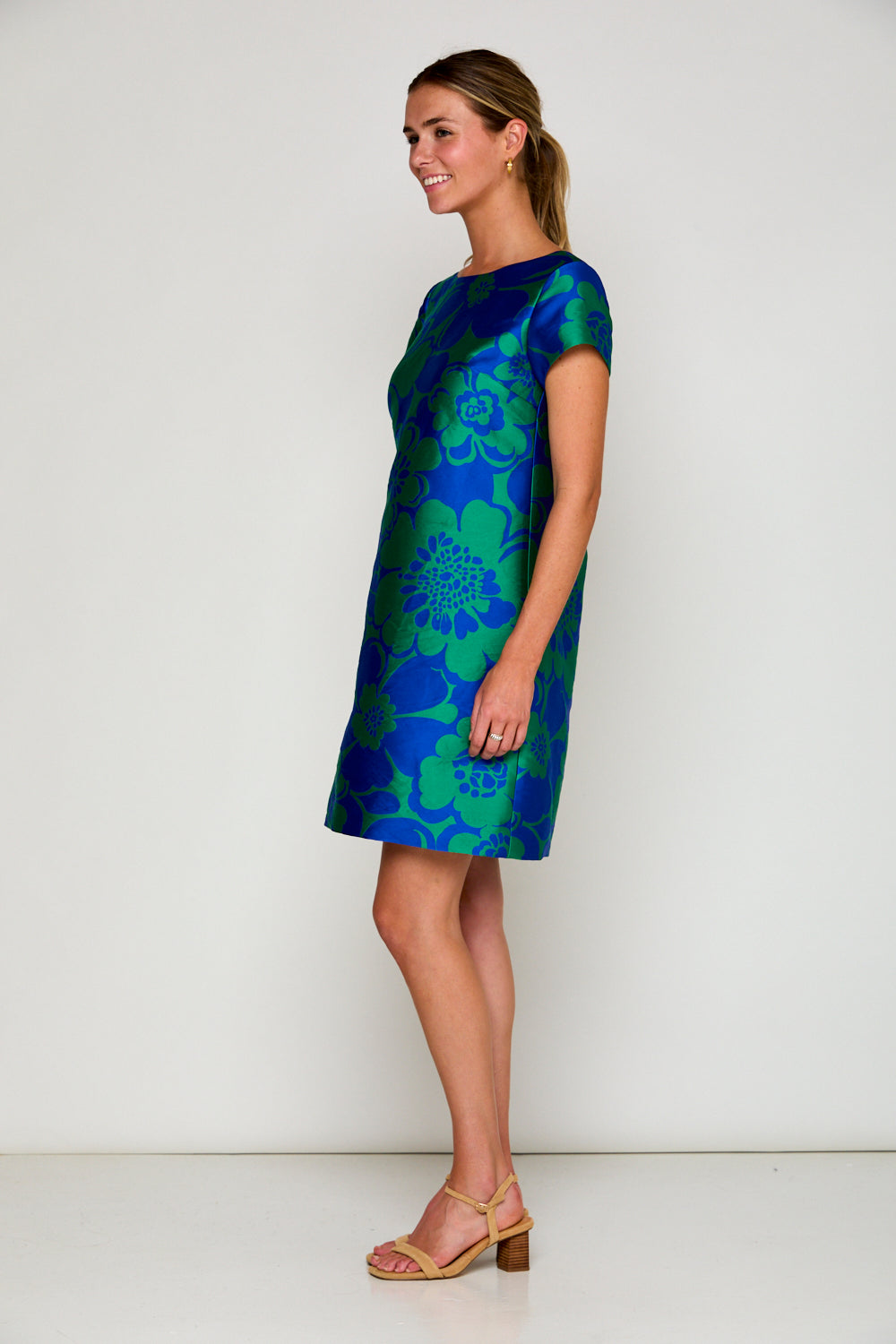 Woman in blue and green floral dress