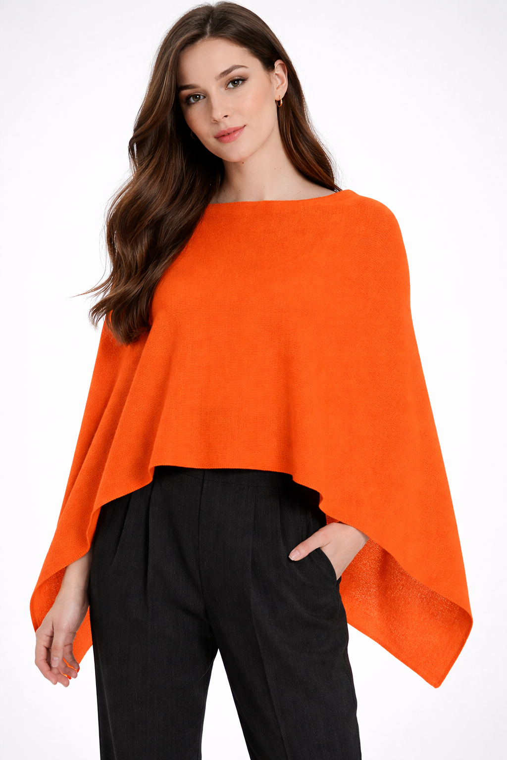 Woman wearing an orange poncho over a black outfit on a white background
