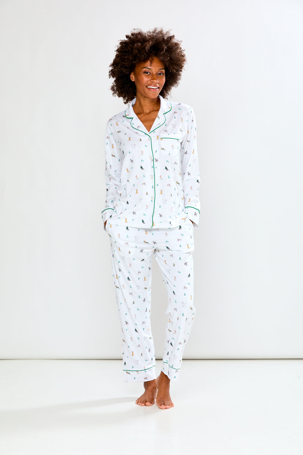 Woman wearing a white pajama set with a dog pattern on a white background