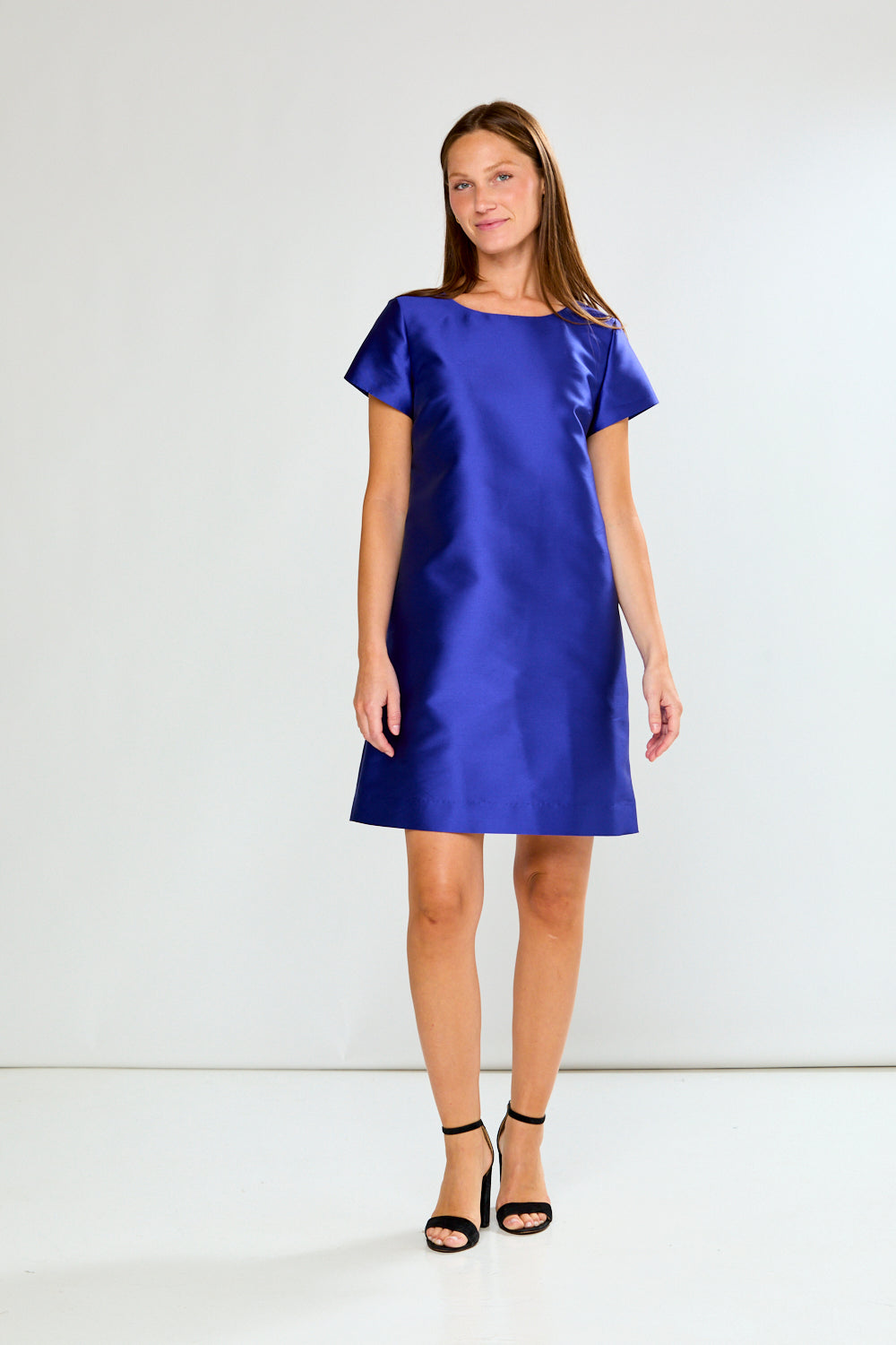 Woman wearing a blue dress against a white background