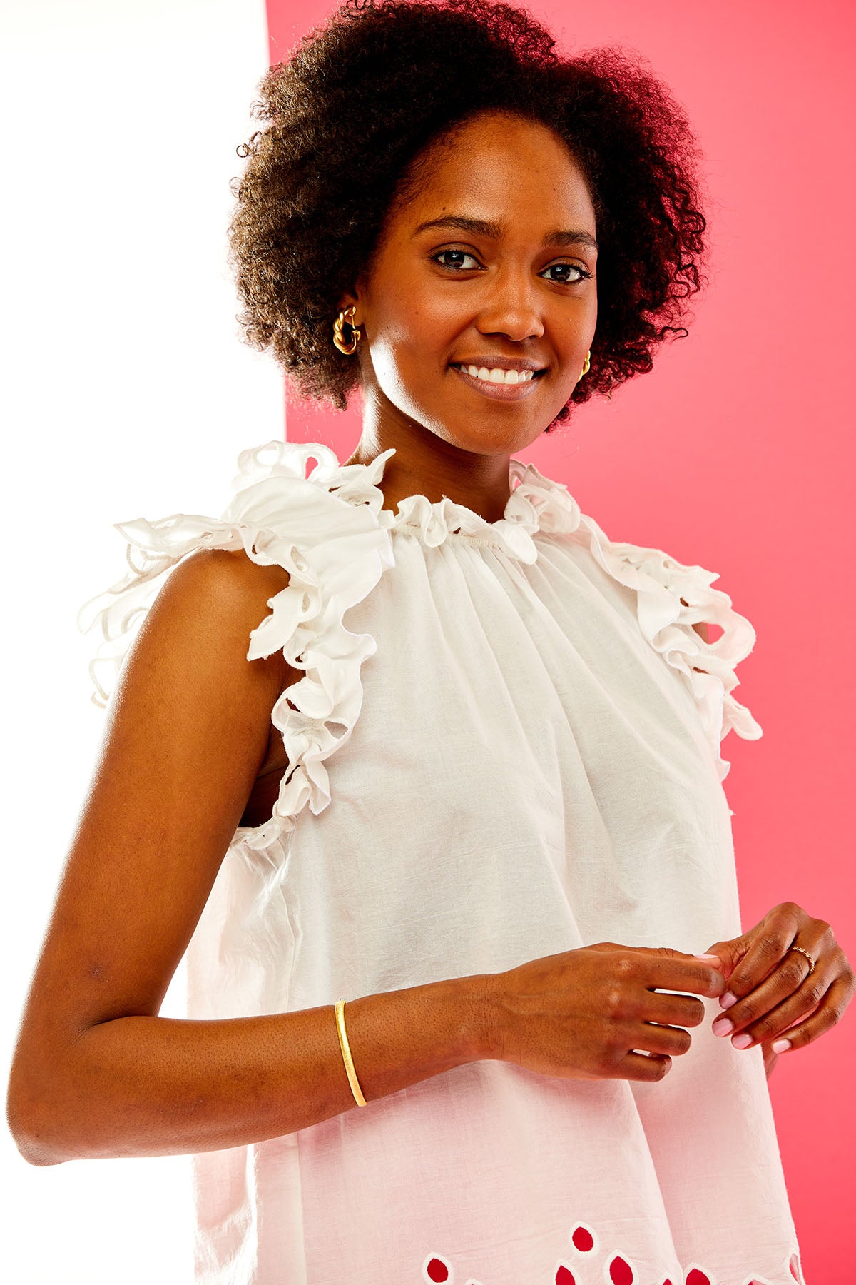 Woman in white blouse with eyelet ruffles