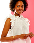 Woman in white blouse with eyelet ruffles