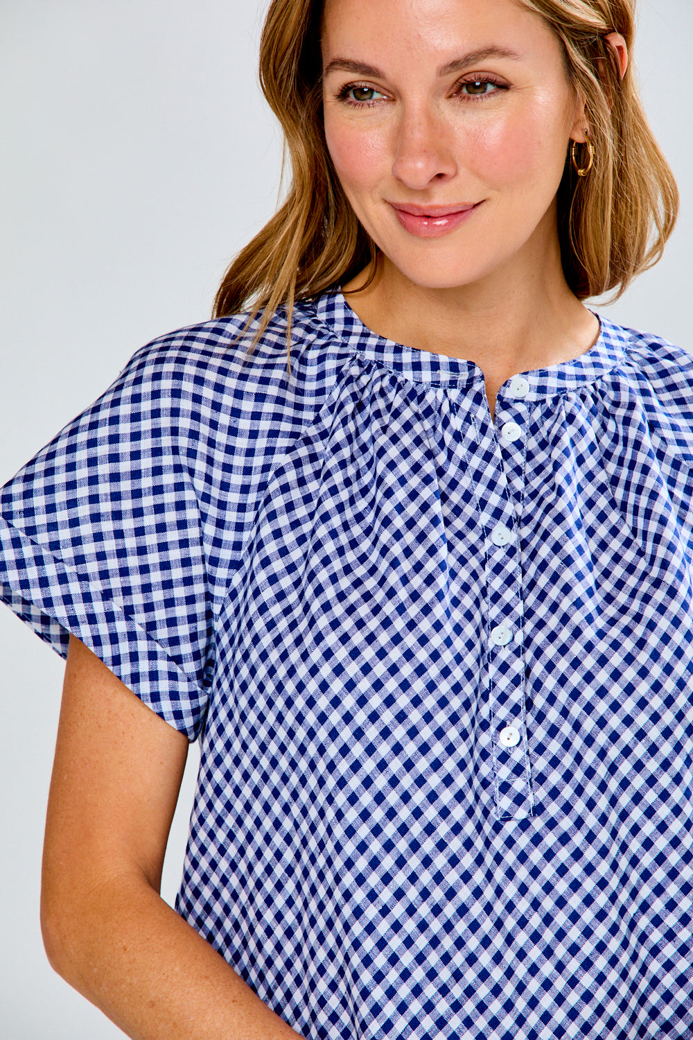 woman in navy gingham top