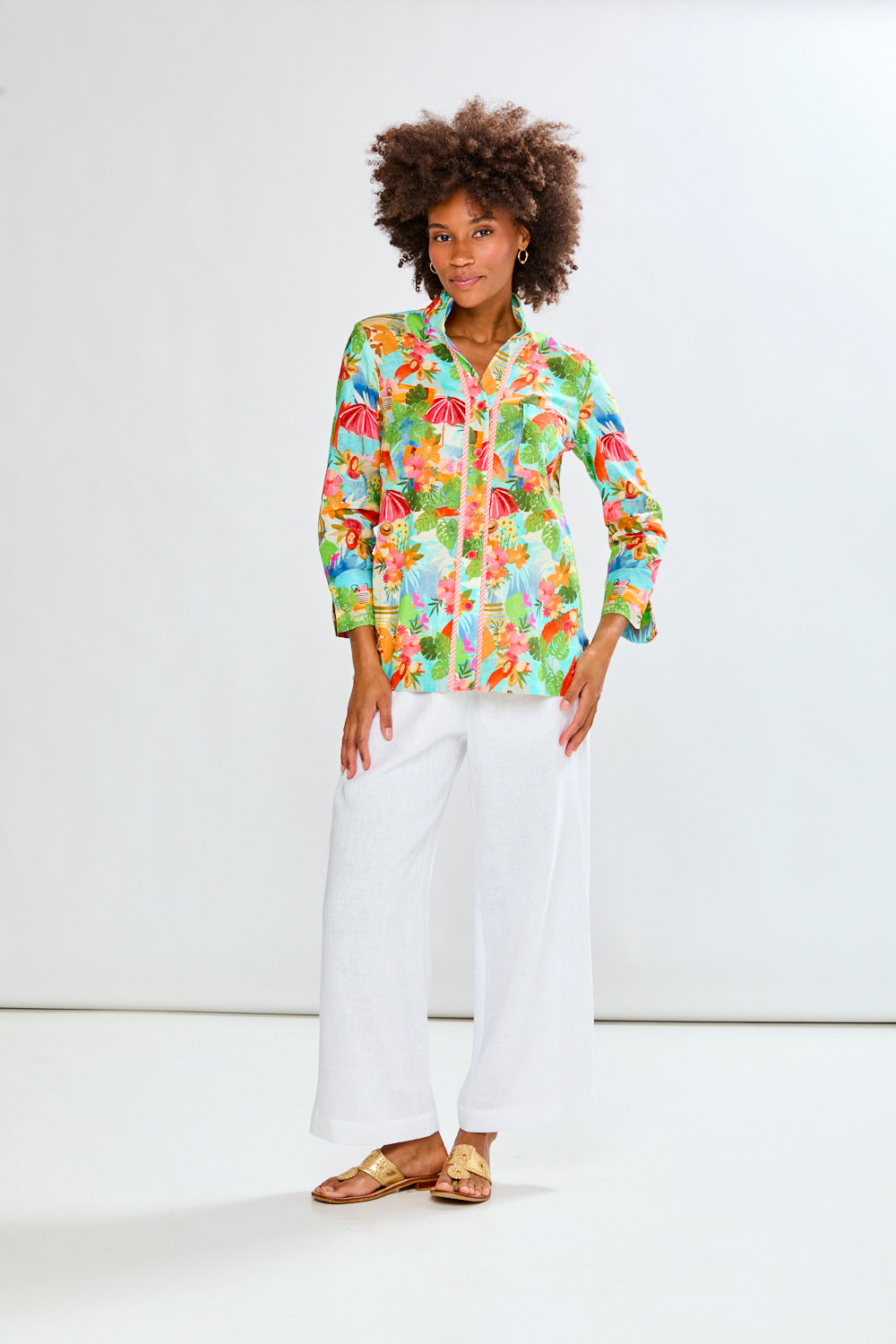 woman in tropical shirt and white pants