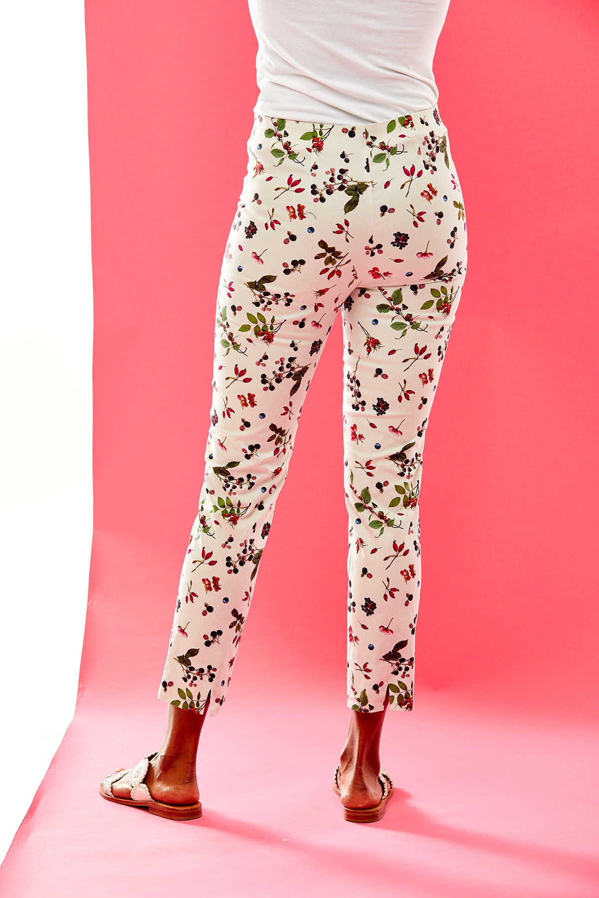 Woman in white pants with a berry print