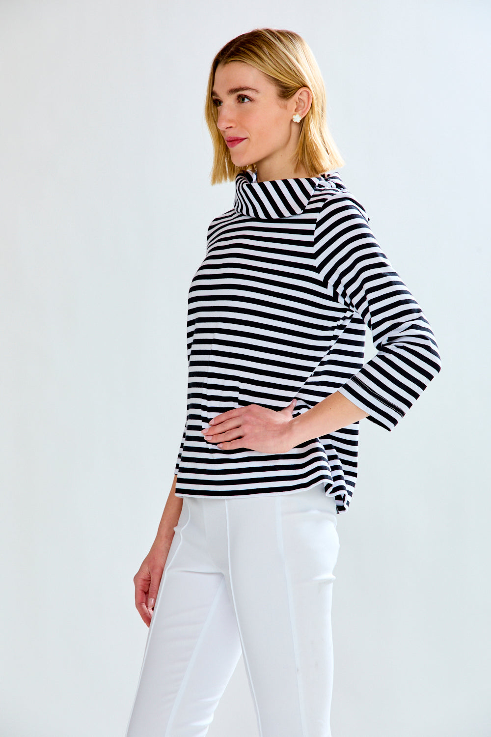 Woman in a white and black striped knit top