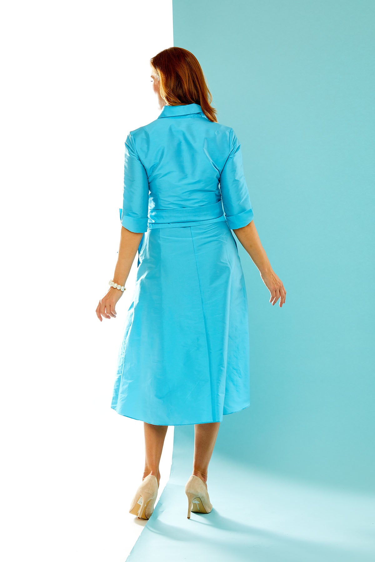 Woman in aqua tea length dress