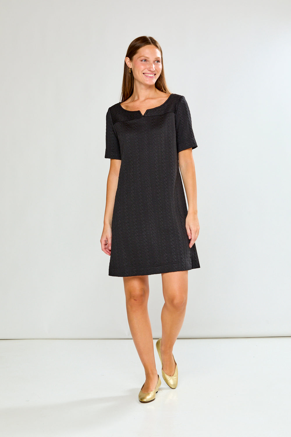 Woman wearing a black dress with a white background