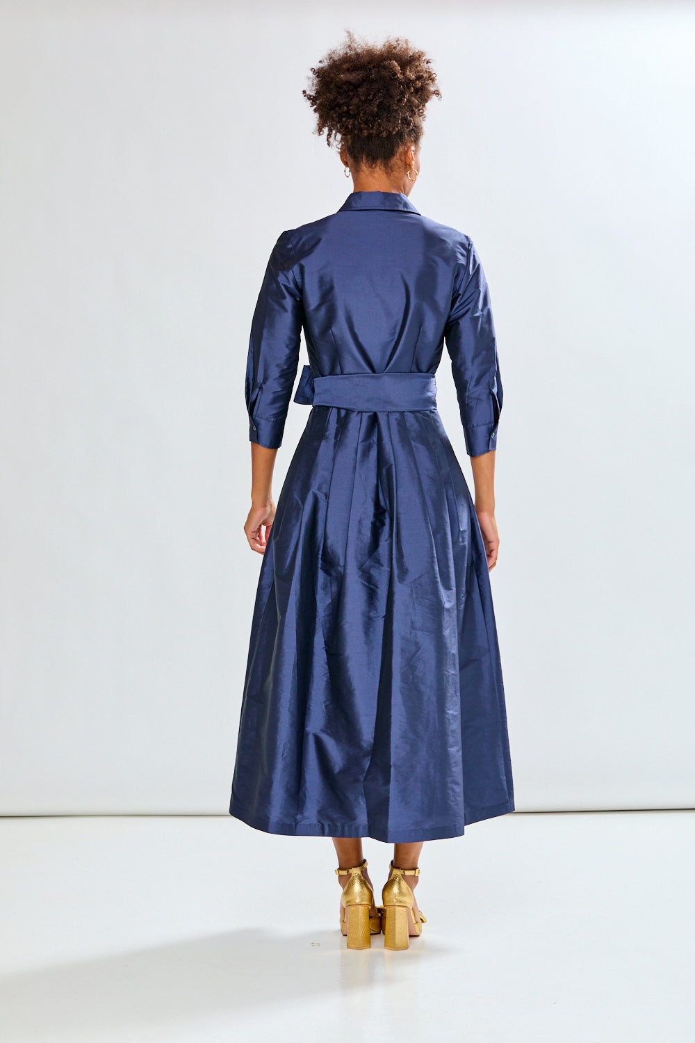 Woman in navy long taffeta dress