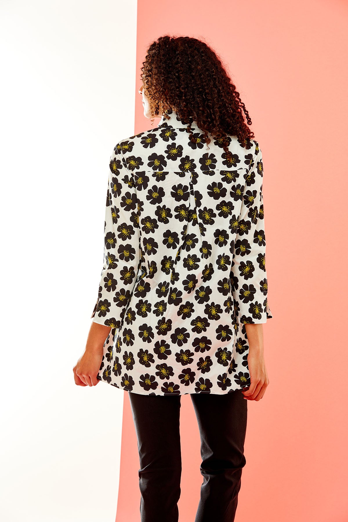Woman in black floral tunic