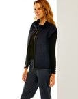 Woman in navy quilted corduroy vest