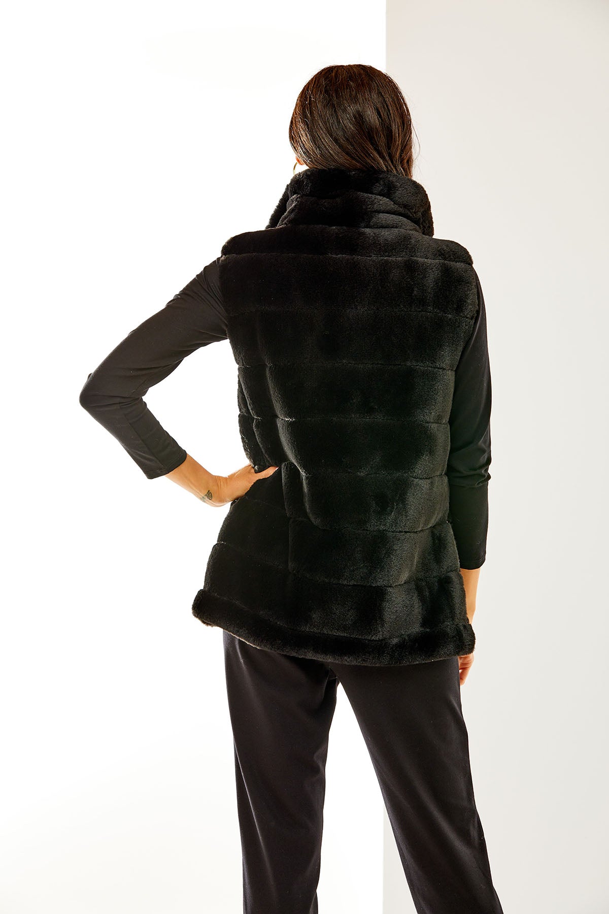 Woman wearing a black faux fur vest