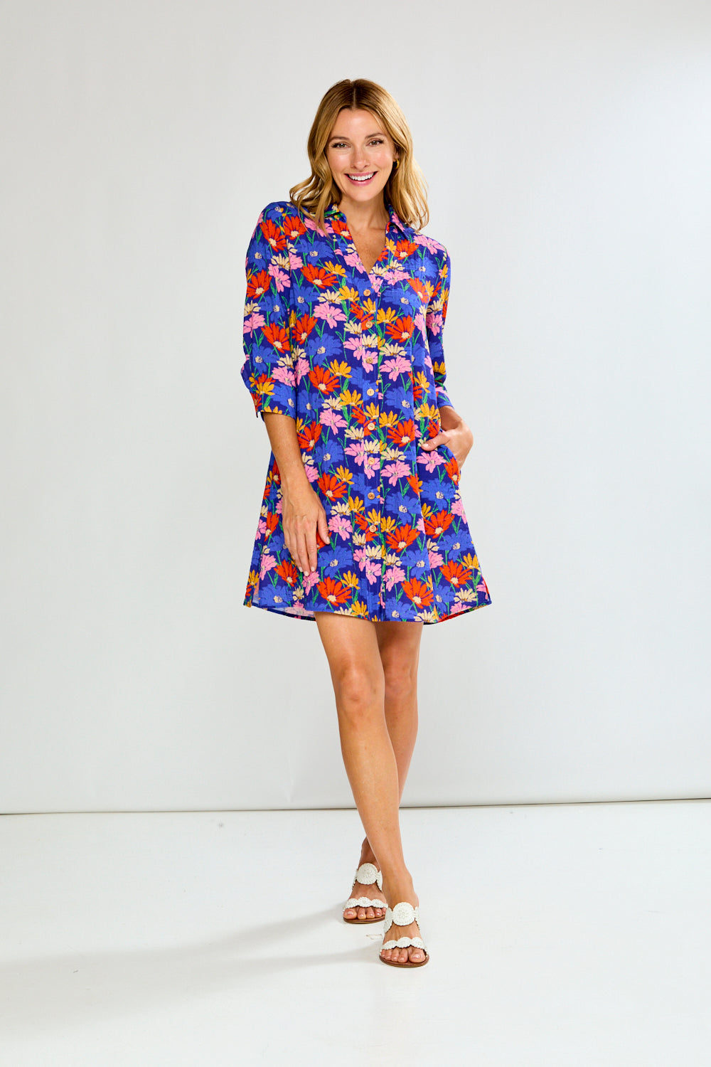 Woman wearing a colorful floral dress on a white background