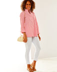 Woman in coral and white stripe shirt