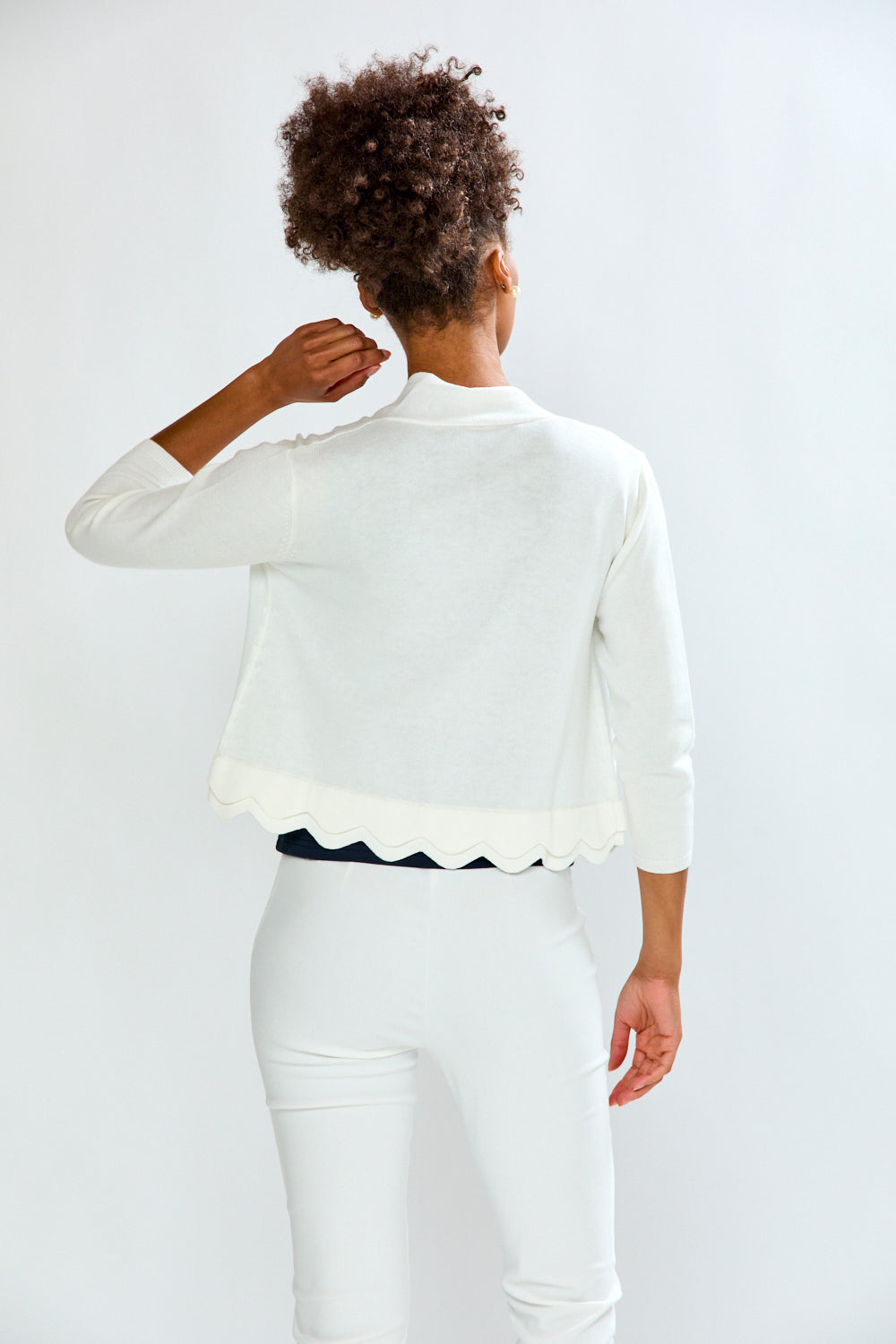 woman in white scalloped sweater