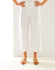 Woman in white pant with scallop hem