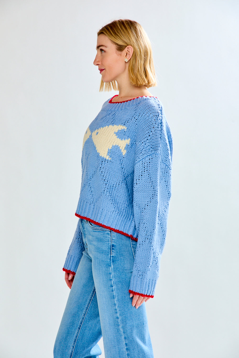 Woman with blue fish sweater on