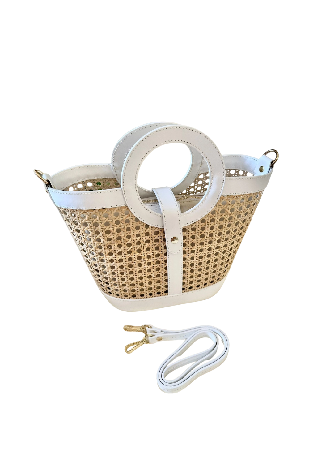 Woven handbag with white handle and strap on a white background