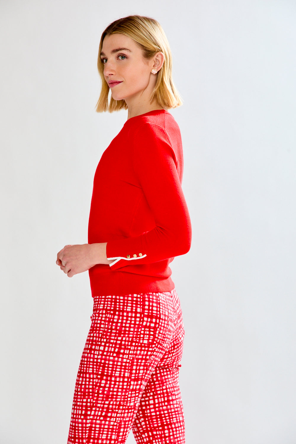 woman in red sweater and patterned pants