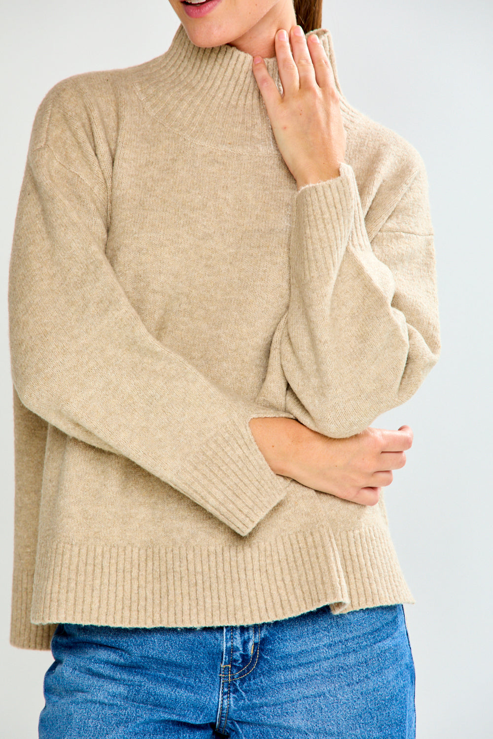 Woman in oat sweater with jeans