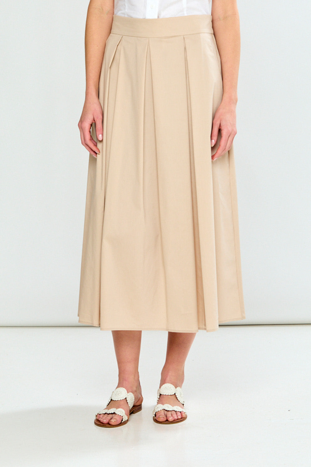 Beige skirt worn by a person on a white background
