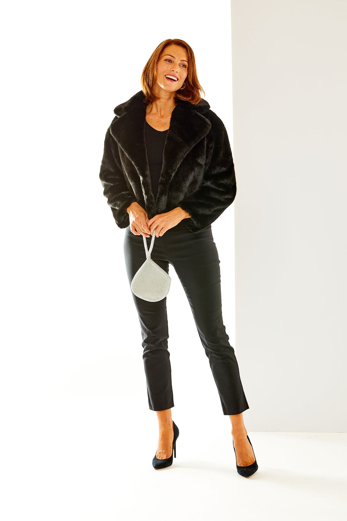Woman in black faux fur jacket