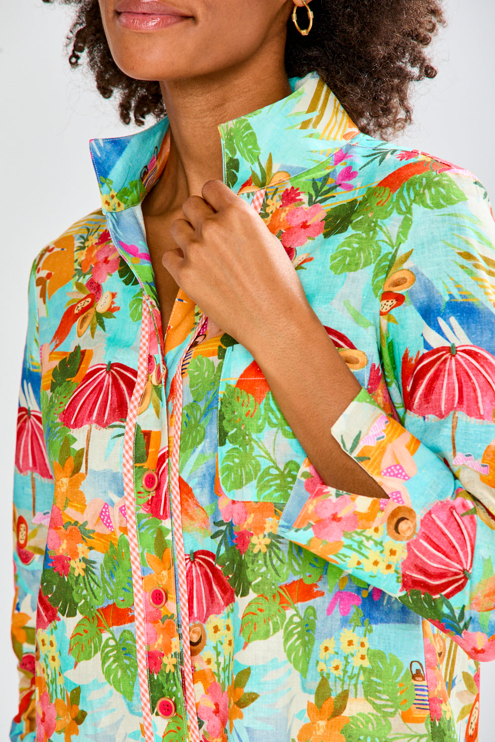 woman in tropical shirt and white pants