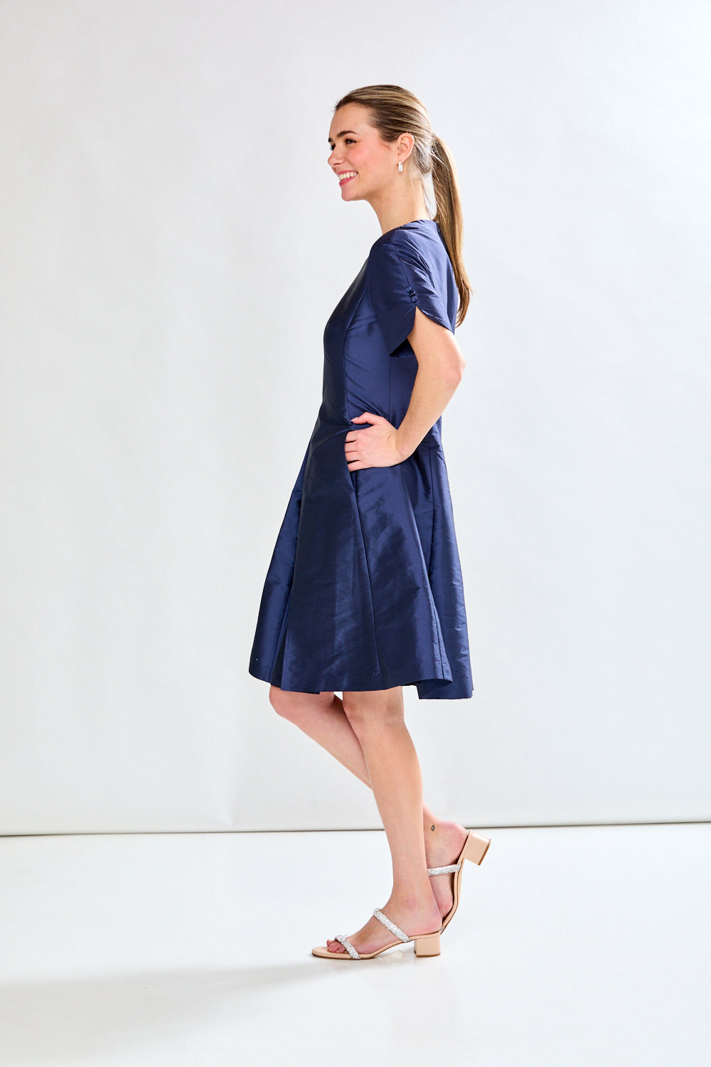 Woman in navy taffeta dress