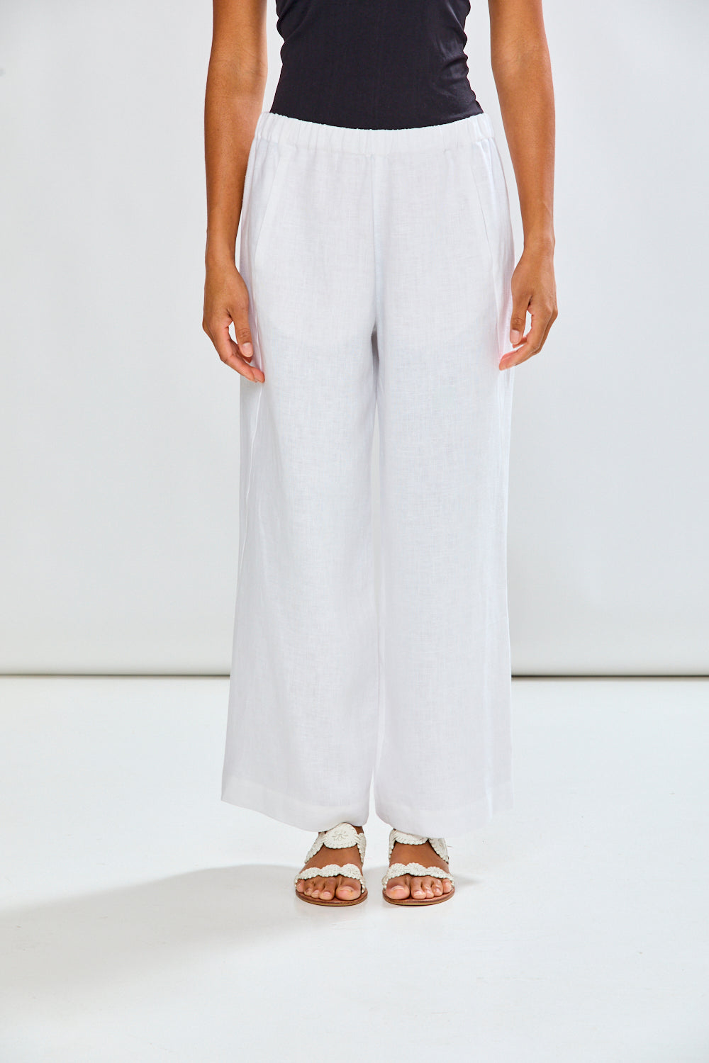 Woman in white linen pants