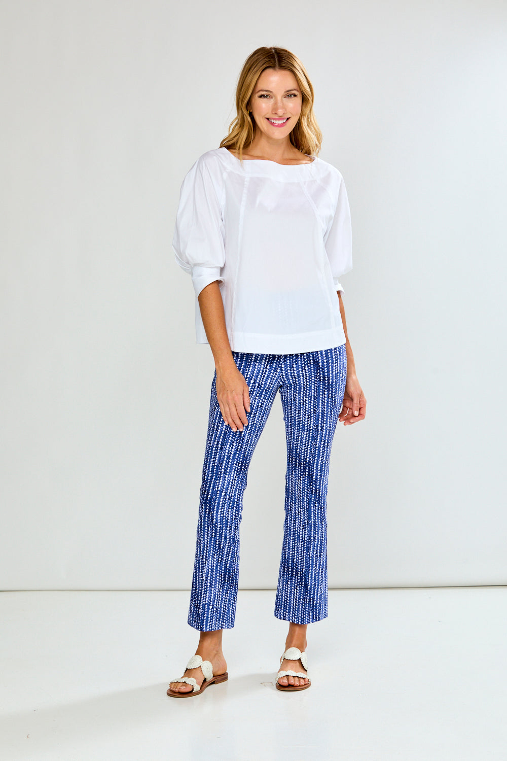 Woman wearing blue and white patterned pants on a white background