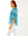 Woman in blue paisley blouse