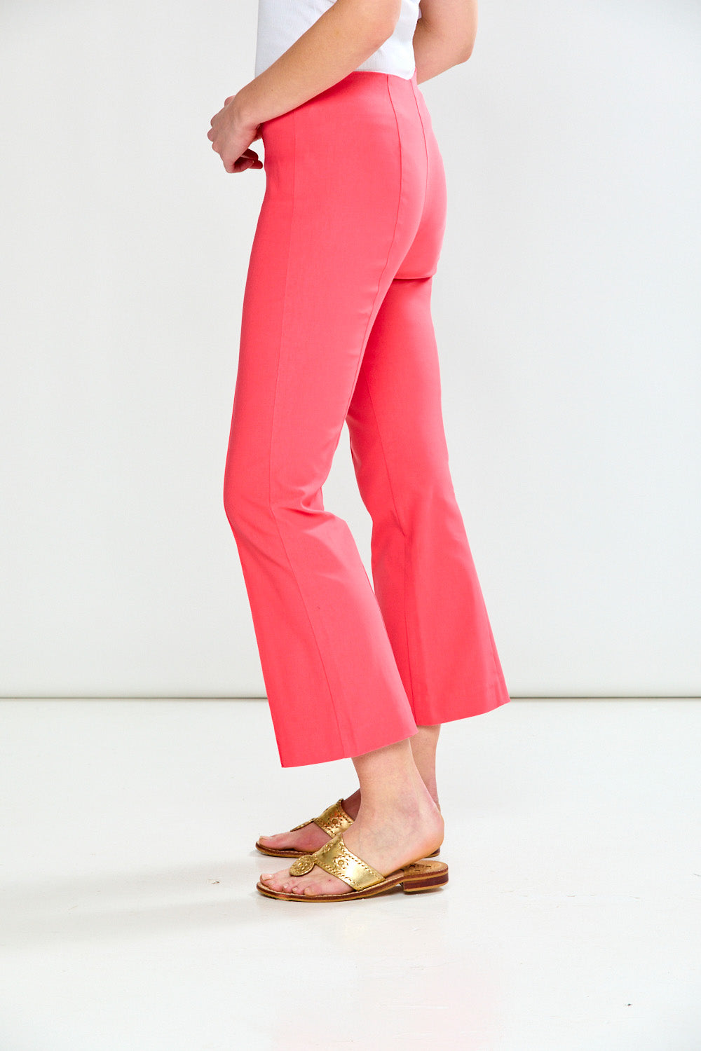 Person wearing guava pants on a white background
