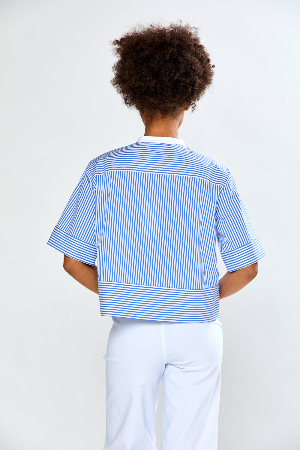 Woman in blue and white striped blouse