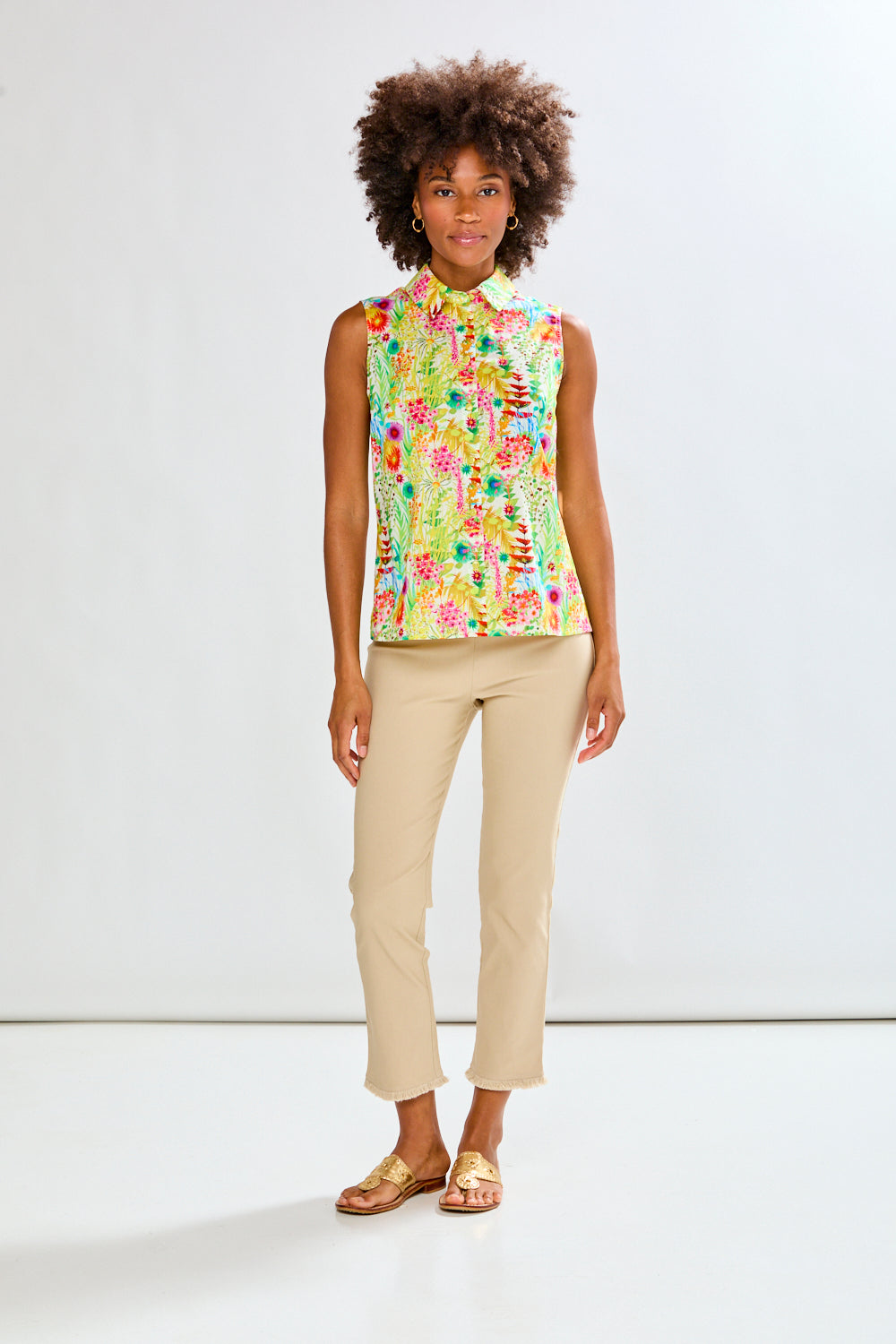 Woman in floral shirt and tan pants 