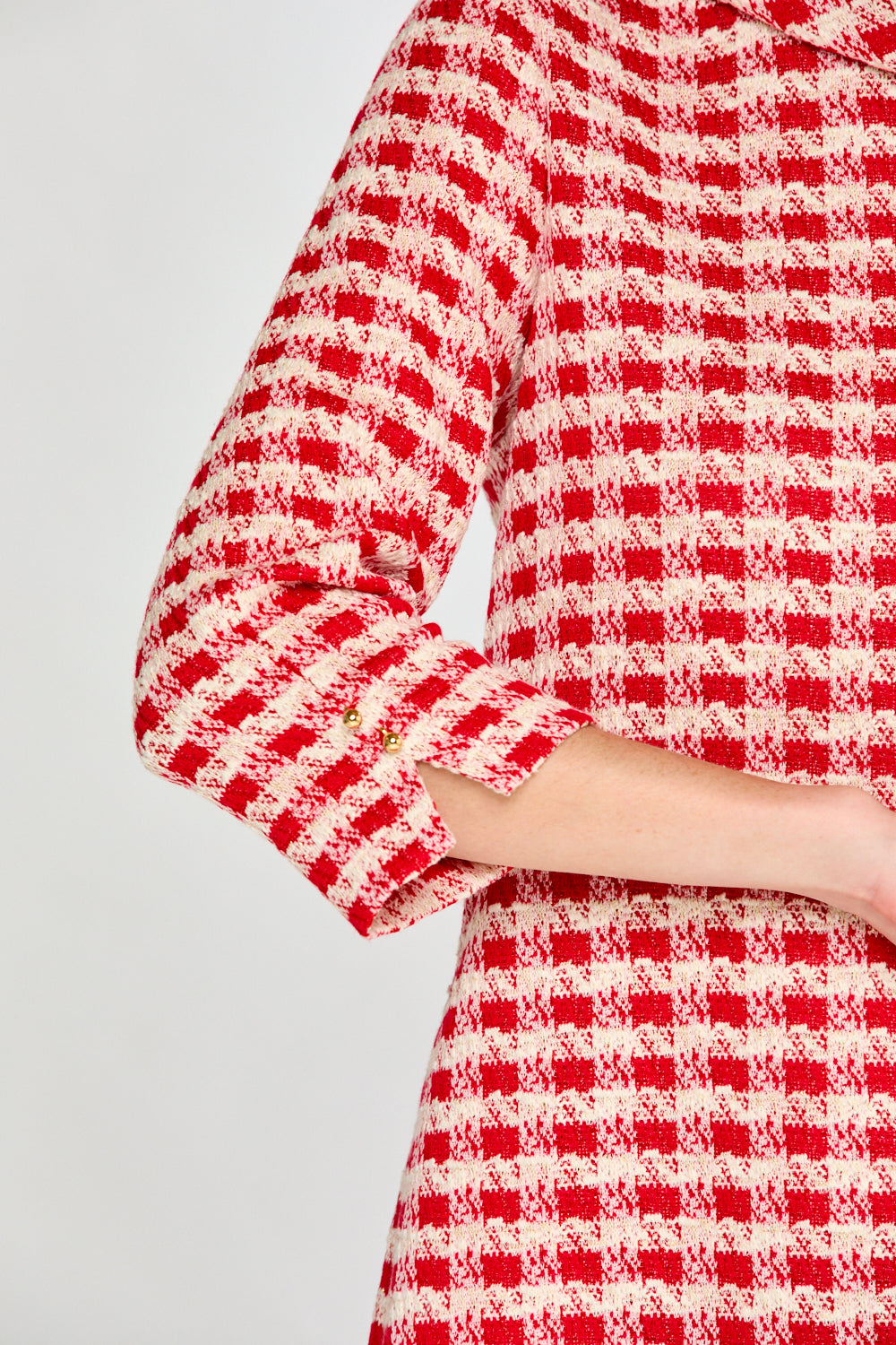 Red and white checkered dress with long sleeves on a light gray background