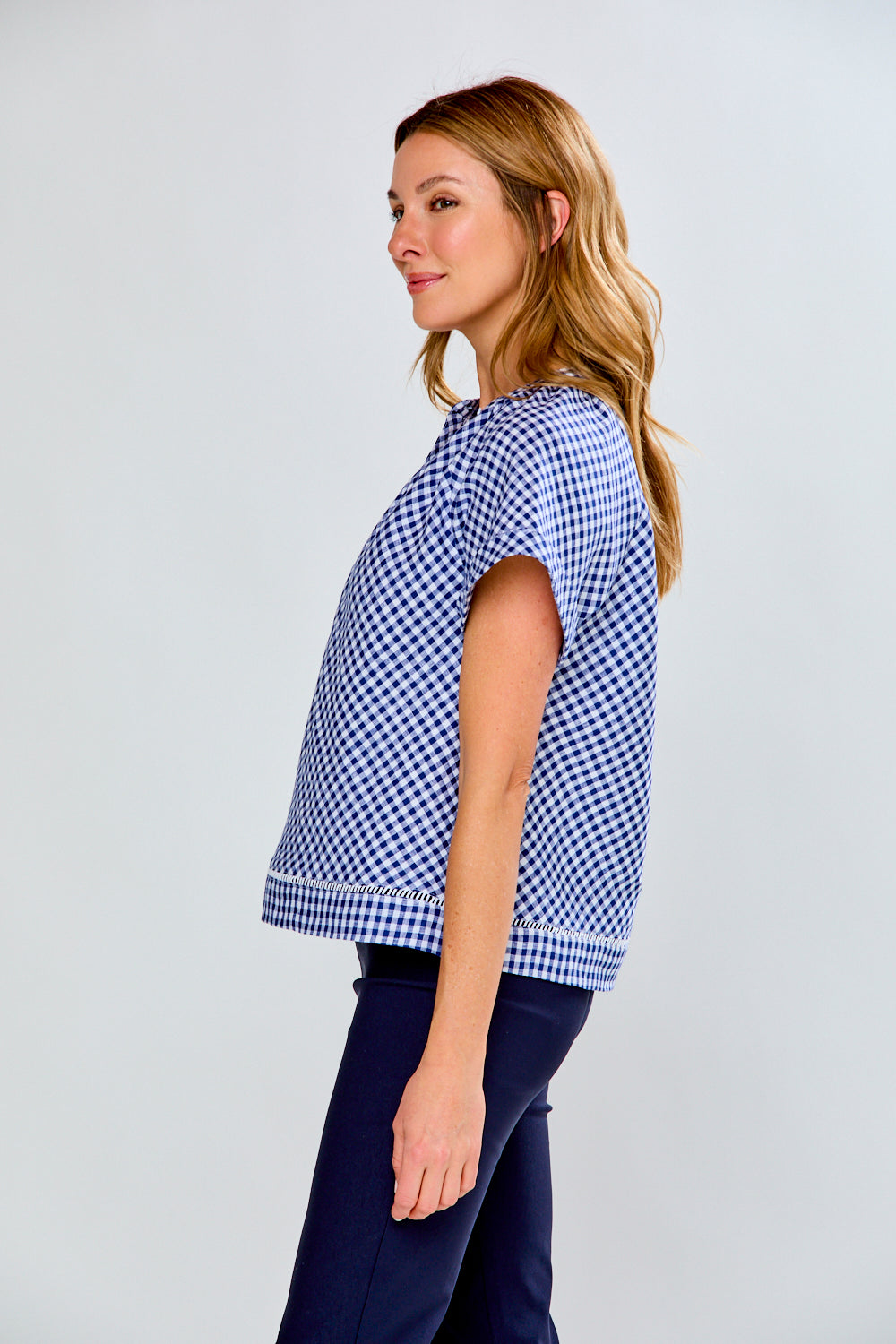 woman in navy gingham top