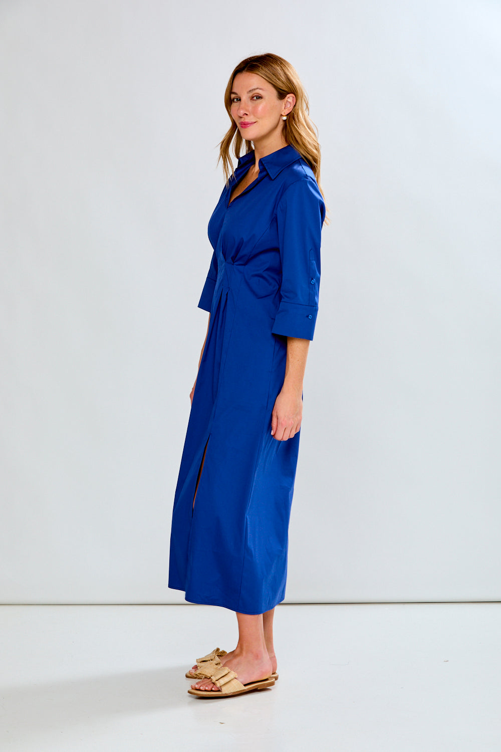 Woman wearing a blue dress against a white background