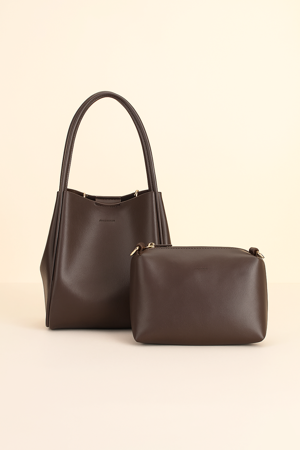 Brown handbag with matching pouch on a beige background