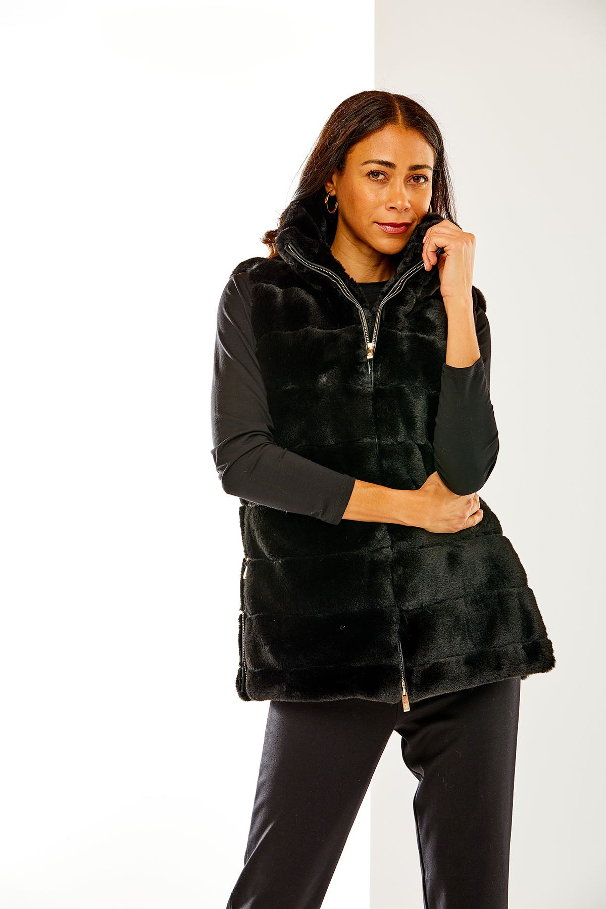Woman wearing a black faux fur vest