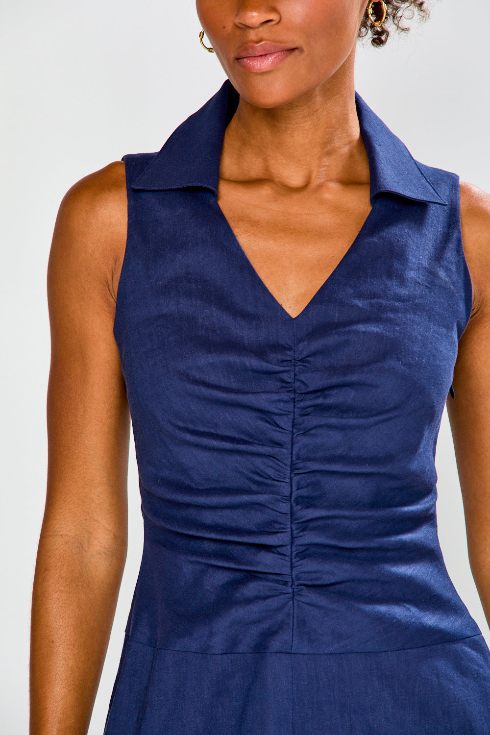 Navy blue sleeveless dress worn by a model on a light gray background
