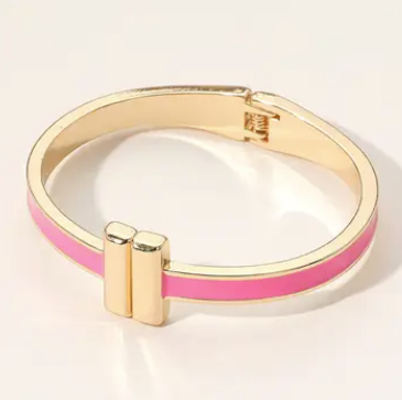 Gold and pink bracelet on a light beige background