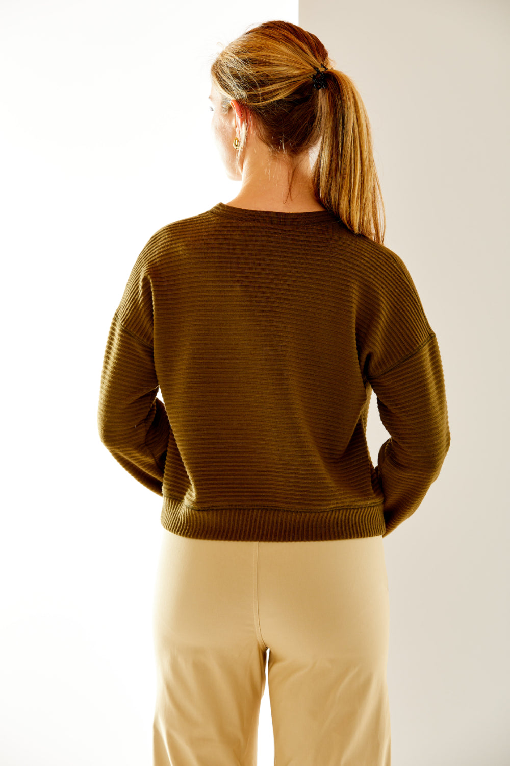 Woman in olive ribbed top