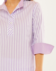 Woman in lilac and white striped top