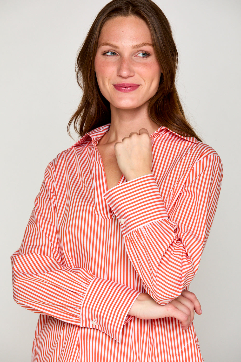 Woman in orange and white striped top