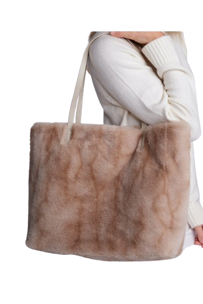 Brown fur tote bag held by a person wearing a white sweater on a white background